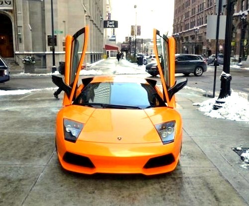 Orange Lamborghini Parked in Snow
