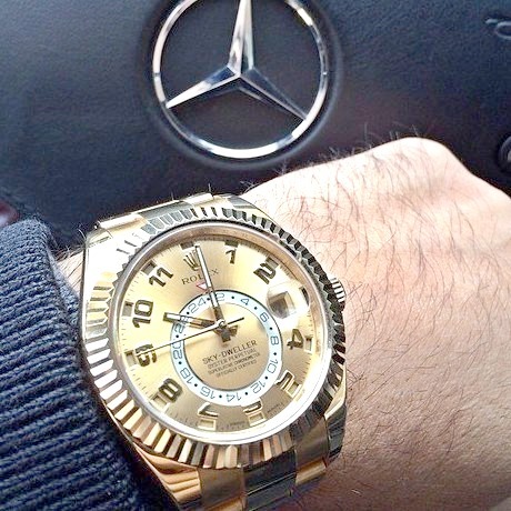 Gold Rolex and a Mercedes Benz